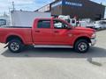 Red 2012 RAM 2500 pickup truck with a crew cab and a black bed toolbox visible on the side