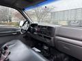 Interior view of a 2000 Ford F-450 showing the dashboard steering wheel and front seat with seatbelt visible