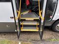 2020 Chevrolet Express with open doors revealing steps into the vehicle marked with a caution sign to watch your step