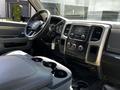 Interior of a 2015 RAM 5500 featuring a dashboard with controls and a steering wheel with a leather-wrapped center console and cup holders