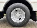 A close-up of a 2016 International CE300 tire showing a silver wheel rim and a black tire with tread patterns