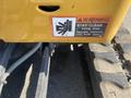 A close-up view of a warning sticker on a 2022 John Deere machinery with instructions to stay clear and operate controls only from the seat