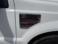 A 2008 Ford F-250 Super Duty badge with a chrome finish and red accents displaying the model name and engine information