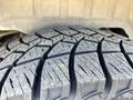 Close up of a tire tread on a 2013 Ford Expedition showing the detailed patterns and grooves of the rubber surface