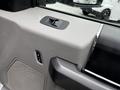 Interior door panel of a 2020 Ford F-350 SD featuring window controls and speaker grille