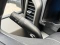 Close-up of the turn signal and windshield wiper control lever inside a 2017 Ford F-350 SD truck