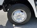 Close-up of a silver wheel with visible lug nuts and a black tire branded as Michelin on a 2009 Morgan Olson Workhorse vehicle