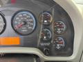 Dashboard of a 2011 International 4300 showing speedometer fuel gauge voltmeter and air pressure gauges