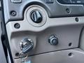 The interior dashboard panel of a 2004 Sterling LT9500 featuring the ignition switch key slot a dimmer switch and an engine start button