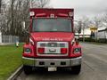 A red 1995 Freightliner FL70 fire rescue truck with a front grille and lights visible, featuring the text FIRE/RESCUE on the hood