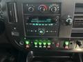 Dashboard of a 2017 Chevrolet Express featuring a radio display and various control buttons in green and black