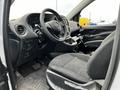 The interior of a 2018 Mercedes-Benz Metris featuring a steering wheel fabric seats and a central console with controls
