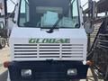 Front view of a 2015 Global Street Sweeper showcasing the grille with the logo and auxiliary mirrors