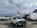 A white 2008 Ford Econoline van with an elevated bucket lift attached to the roof
