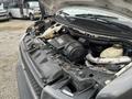 A 2017 Chevrolet Express with its hood open displaying the engine and various components inside the engine bay