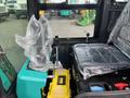 A 2024 AGT Industrial Green QH13R Mini Excavator with wrapped joystick controls and seat visible in the foreground