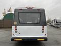 A 2018 Chevrolet Express viewed from the rear with a white exterior and red tail lights