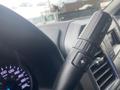Close-up of a 2017 Ford F-550 steering wheel with various controls including a gear shift lever and a speedometer in the background