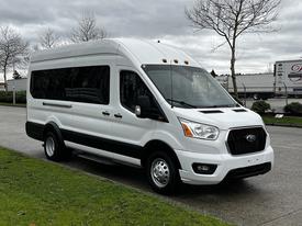 2021 Ford Transit van in white with black accents featuring large windows and a spacious cargo area