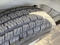 Close-up of a heavily treaded tire from a 2021 RAM Promaster showcasing its grooves and wear patterns