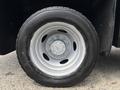 Close-up of a silver wheel on a 2017 Ford F-550 with a black tire showcasing multiple lug nuts and a central hub