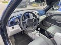 Interior view of a 2007 Chrysler PT Cruiser showing the dashboard steering wheel and front seats with a manual gear shift and various controls