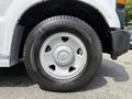 A close-up view of a 2008 Ford F-250 SD wheel with a white rim and a black tire featuring tread patterns