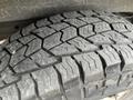 Close-up of a worn tire from a 2014 GMC Savana showing tread patterns and visible wear marks
