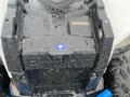 2017 Polaris Scrambler with a black and blue body featuring a prominent star logo on the front and a textured hood design