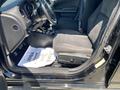 Interior view of a 2019 Dodge Charger showing the driver's seat and dashboard with black fabric upholstery and a floor mat displaying a thank you message