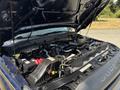 An open hood of a 2014 Ford F-250 SD showcasing the engine compartment with visible components like the battery air intake and various hoses