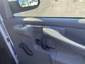 Interior door handle and controls of a 2012 GMC Savana van with a gray finish