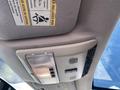 Interior view of a 2006 Land Rover LR3 ceiling console featuring lights and warning labels
