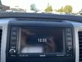Dashboard display of a 2011 RAM 1500 showing the time as 12:33 with various audio control buttons visible