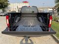 A 2021 Ford F-350 SD with an empty black truck bed showing a textured surface and wheel wells on either side