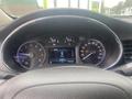 Close-up of a car dashboard showing speedometer and display with odometer reading 157807 kilometers