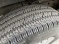 Close-up of a textured tire tread from a 2023 GMC Savana showing deep grooves and patterns designed for traction and stability