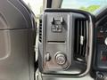 Close-up of the control panel in a 2016 Chevrolet Silverado 2500HD featuring various dials and buttons for vehicle functions and settings