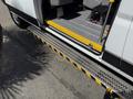 A 2021 RAM Promaster with an open door and a textured step leading into the vehicle's interior