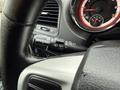 Close-up of the steering wheel and control stalks of a 2017 Dodge Grand Caravan showing the windshield wiper and light controls