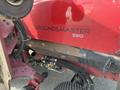 A red Toro Groundmaster 5910 with a visible logo and machinery components attached to the side