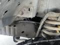 A 2009 Ford Econoline with visible mechanical components including a suspension system and various hoses