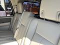 Interior seats of a 2013 Ford Expedition featuring beige leather upholstery and a spacious seating arrangement