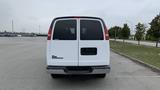 Rear view of a 2017 Chevrolet Express Quigley 4x4 with a white exterior and tinted windows