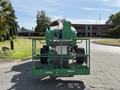 A green 2015 JLG 450AJ boom lift with a platform and large wheels is positioned facing away from the viewer