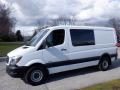 A 2016 Mercedes-Benz Sprinter van with a white exterior and dark accents parked on a driveway