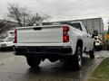 2021 Chevrolet Silverado 3500HD in white with a distinctive rear design showcasing the Chevrolet logo on the tailgate and bold taillights