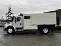 2007 Freightliner M2 106 truck with a white cargo box and side door viewed from the side