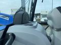 Interior view of a 2016 New Holland T475 tractor showing the dashboard and controls with a focus on the seat and steering column