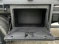 A black storage compartment with a hinged door opened downward on a 2008 International 7500 truck